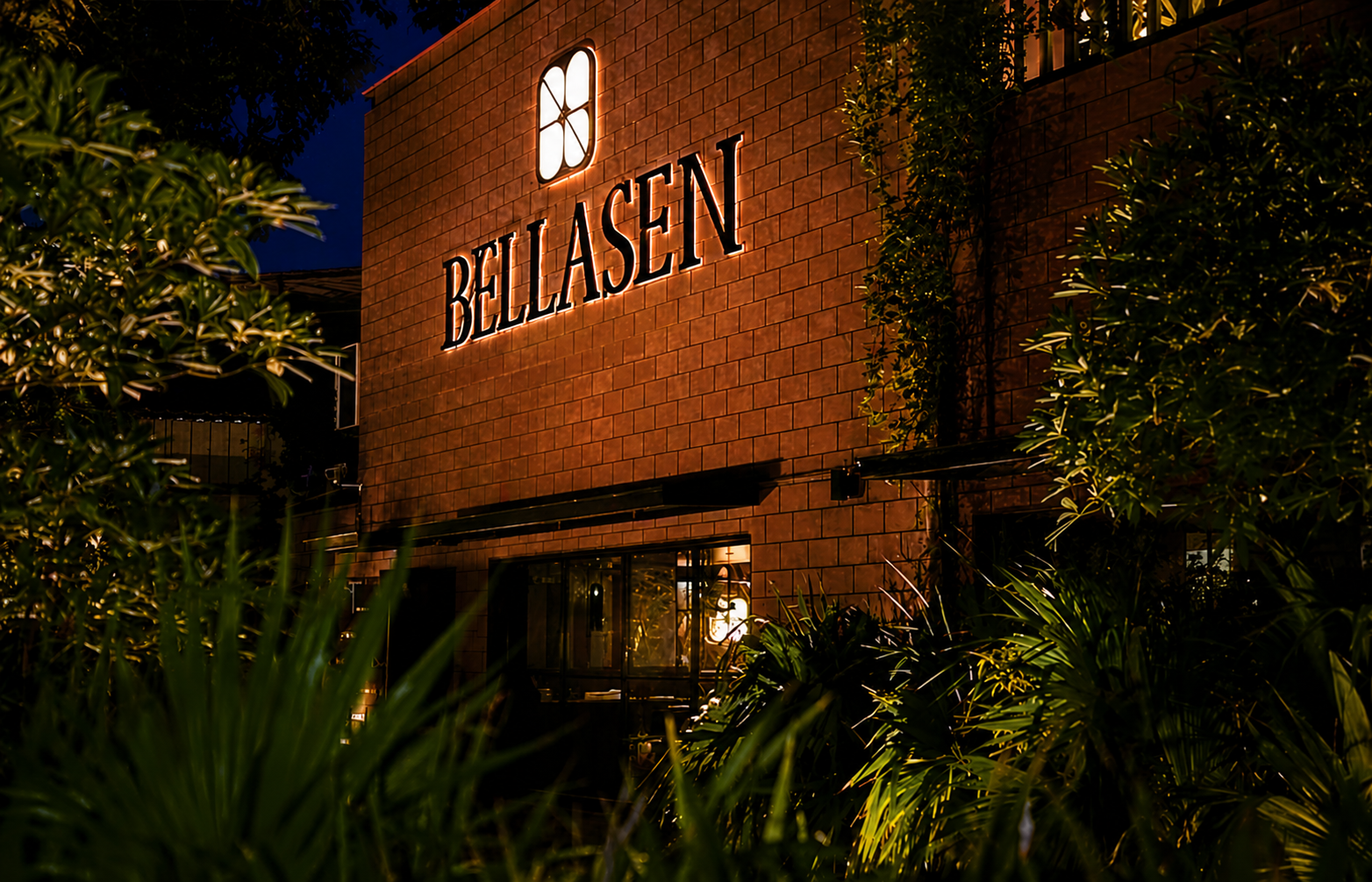 Bellasen restaurant exterior at night, lit signage
